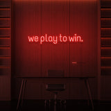 "WE PLAY TO WIN." NEON SIGN