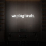 "WE PLAY TO WIN." NEON SIGN